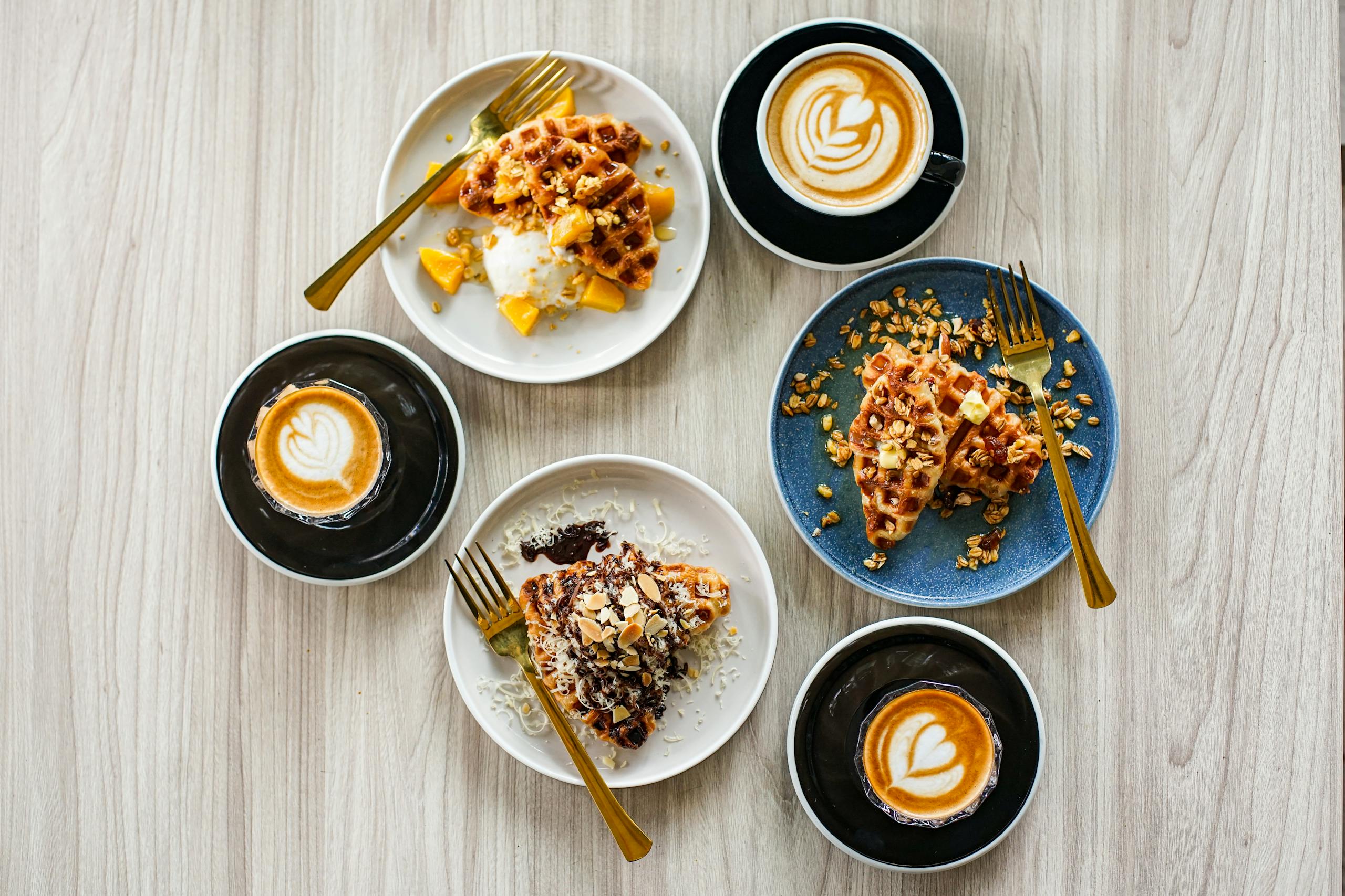 Waffle House Menu with Price 2025 Top view of waffles with fruits and lattes on a wooden table.
